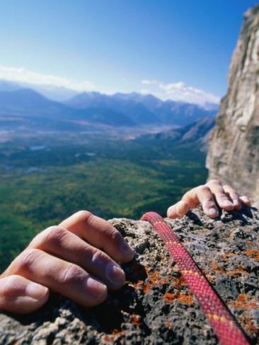 climbers-hands-holding-onto-rock